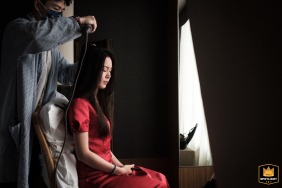 A serene bride in bridal prep at Hotel ICON, Hong Kong, bathed in soft natural window light, radiating a sense of calm before the wedding ceremony.